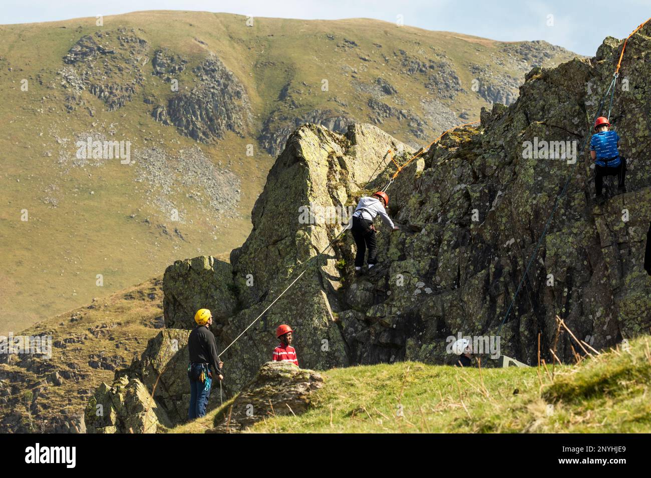 Schulkinder aus der Innenstadt, denen das Klettern in einem alten Steinbruch im Coombs Martindale Ullswater, dem Lake District, Cumbria, beigebracht wird Stockfoto