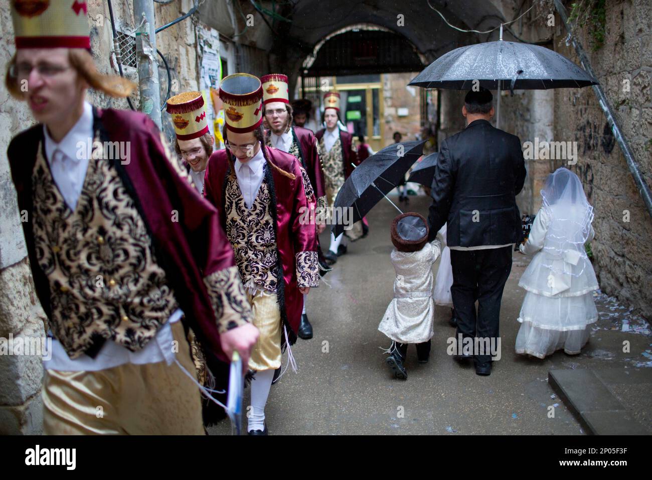 UltraOrthodox Jewish men and children wear costumes during the Jewish holiday of Purim in Mea