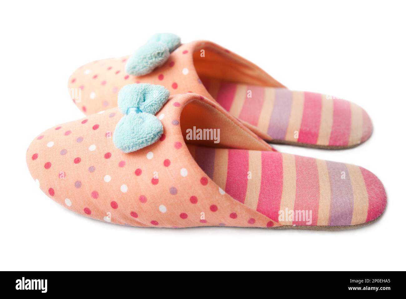 Süße lustige rosa gestreift gepunktet Clown Hausschuhe Mädchen mit blauen Bogen isoliert auf weiss, Seitenansicht Stockfoto