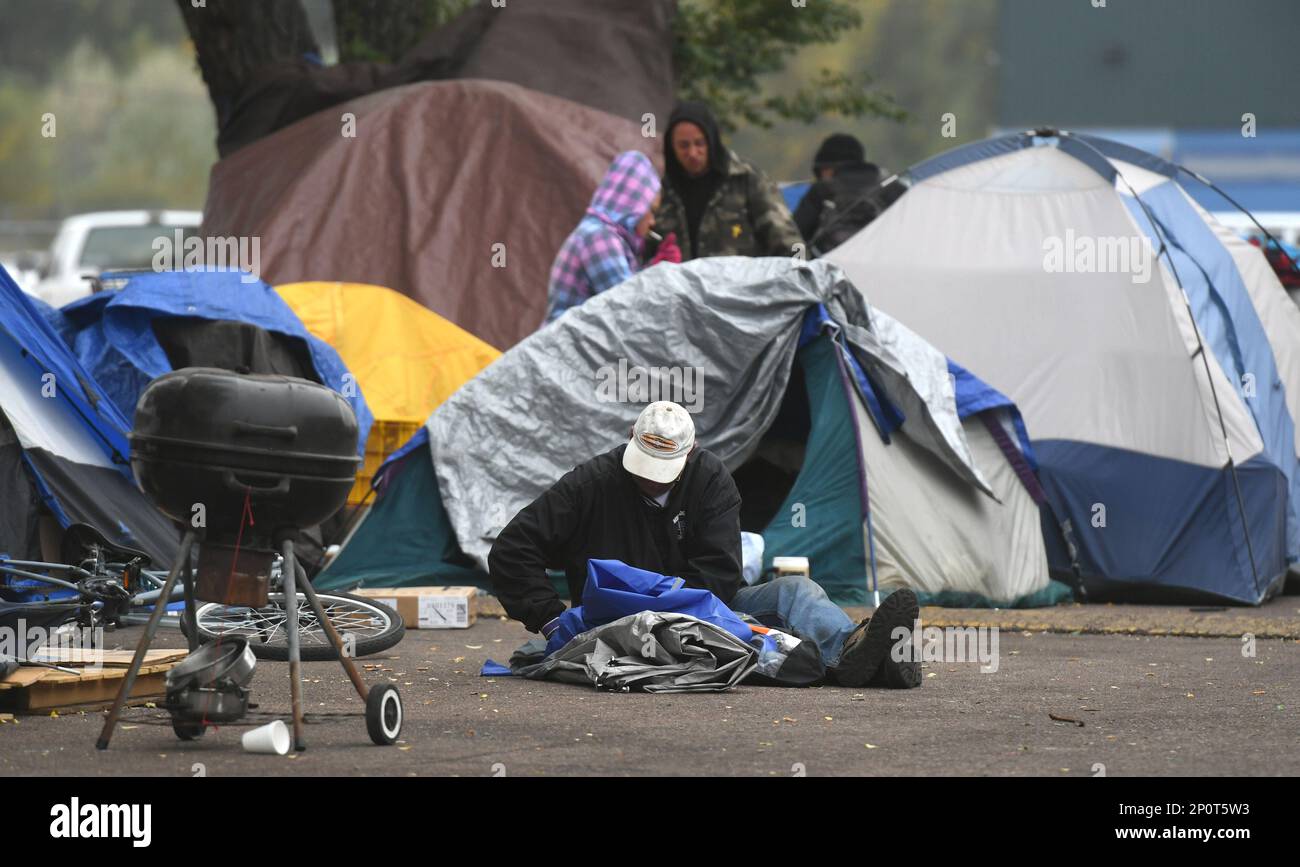 Homeless campers pack up their belongings at a homeless tent city on
