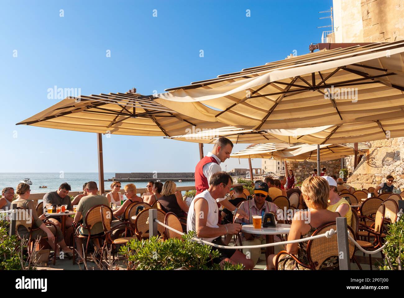 Menschen an der Waterfront Bar in Cefalu, Sizilien, Italien Stockfoto