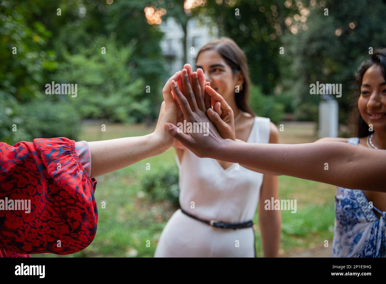 Multiethnische Gruppe weiblicher Freunde, die sich an den Händen halten, internationales Frauentag-Konzept. Stockfoto