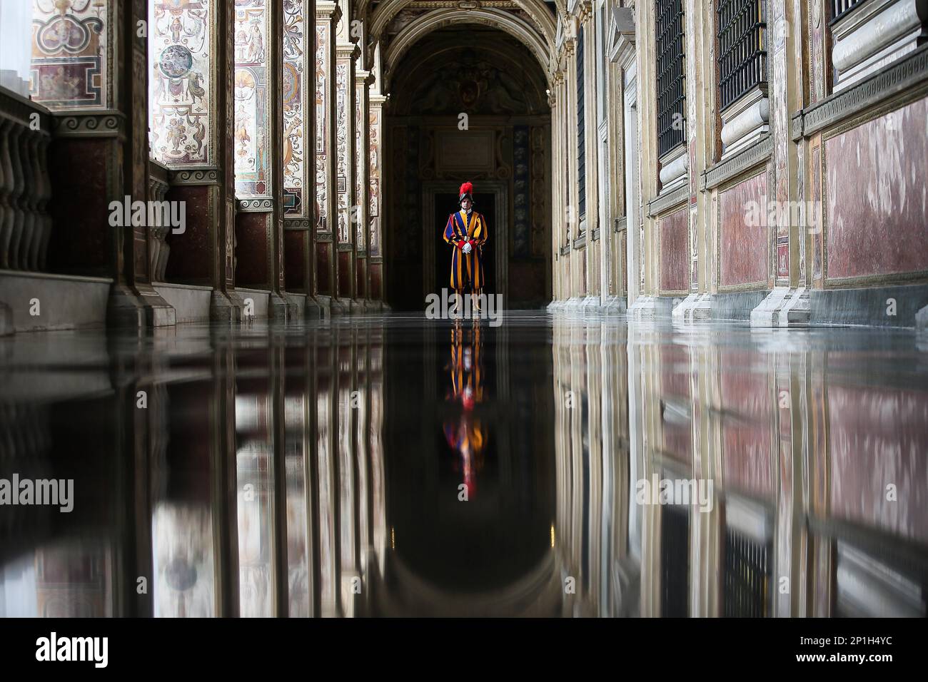 A Vatican Swiss guard stands in the corridor of the entrance of the