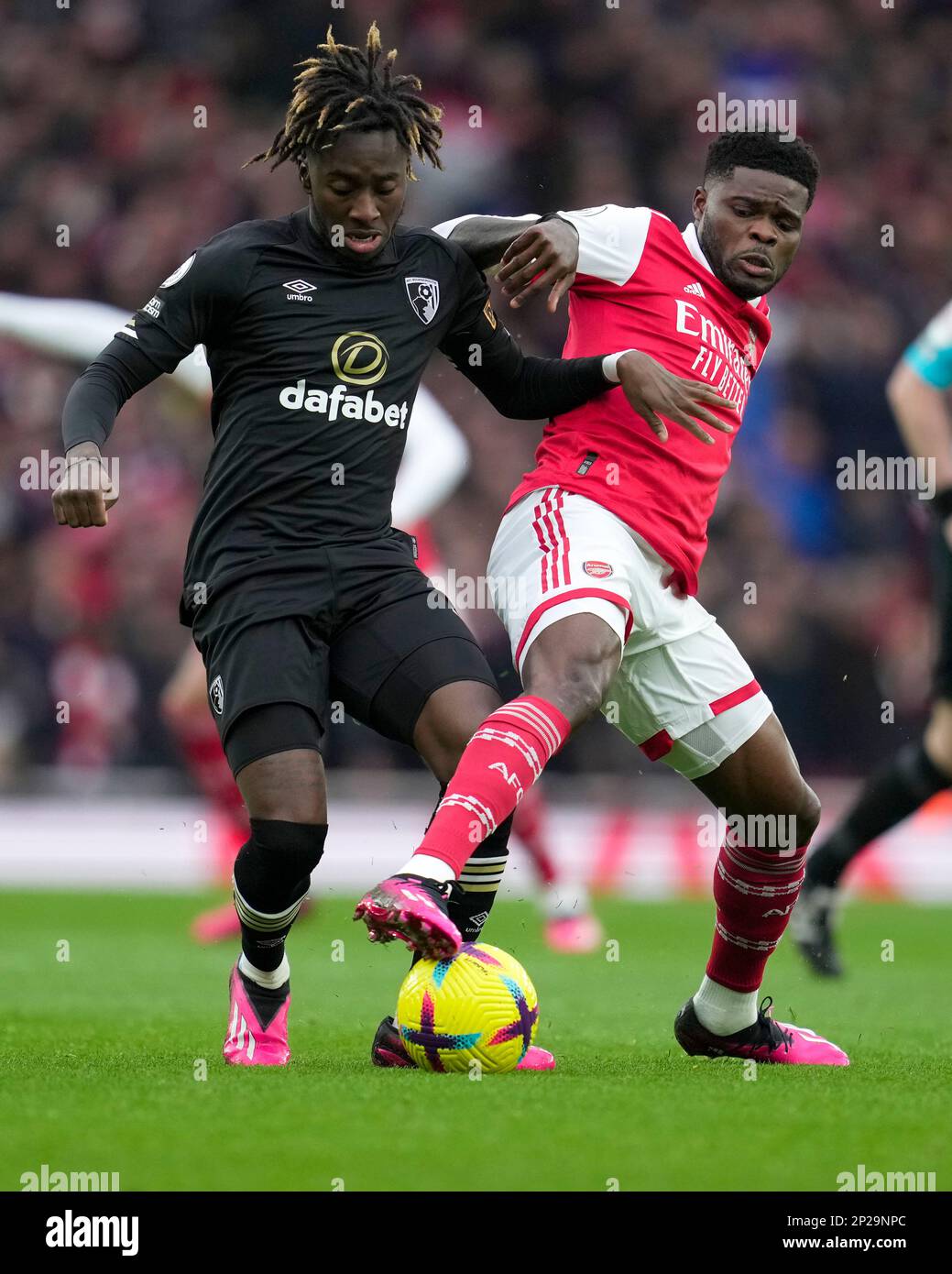 Arsenal's Bukayo Saka, right, challenges Bournemouth's Jordan Zemura ...