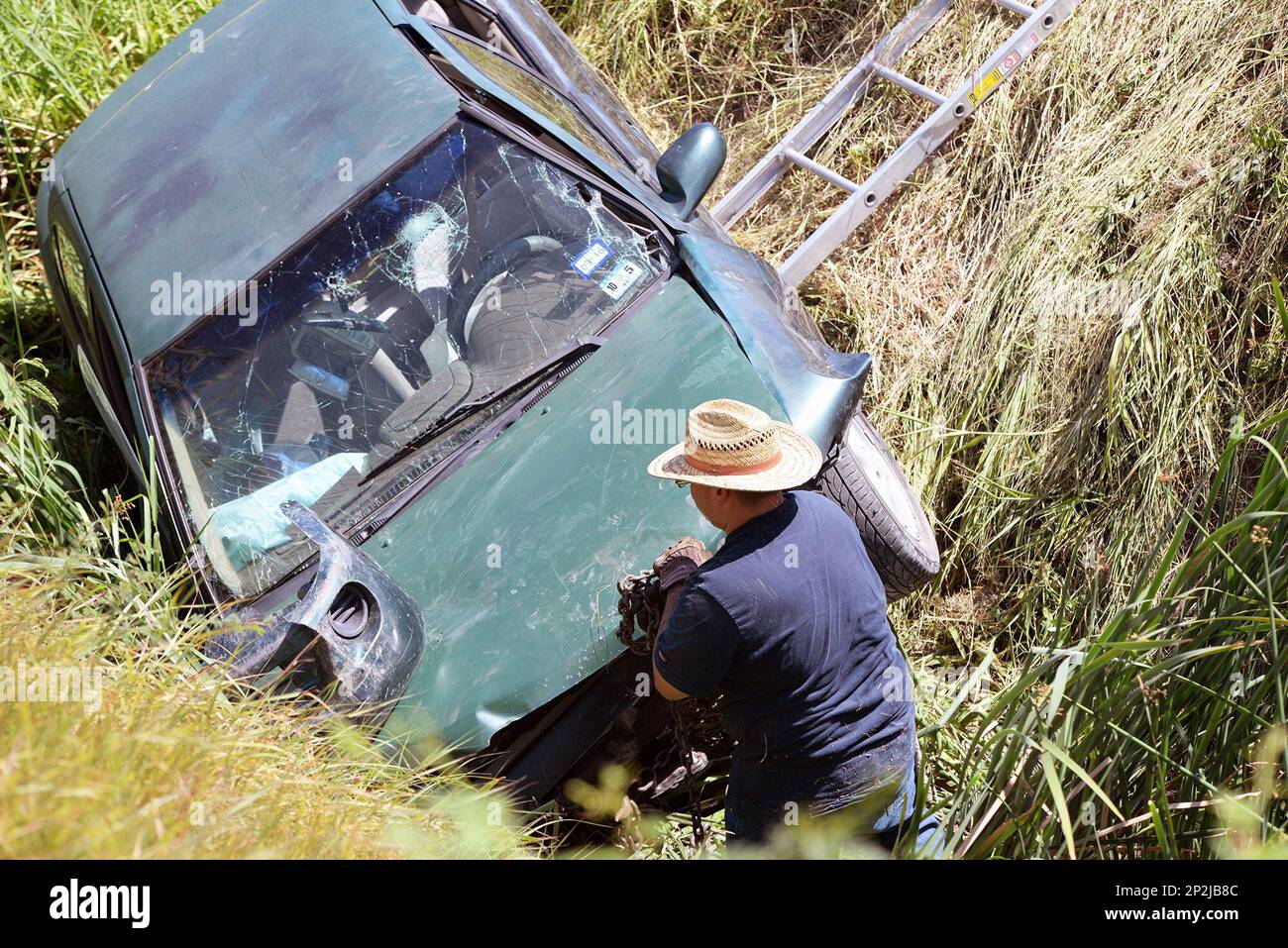 In this photo taken Monday, Aug. 10, 2015, a salvage worker with All ValleyWide Towing checks