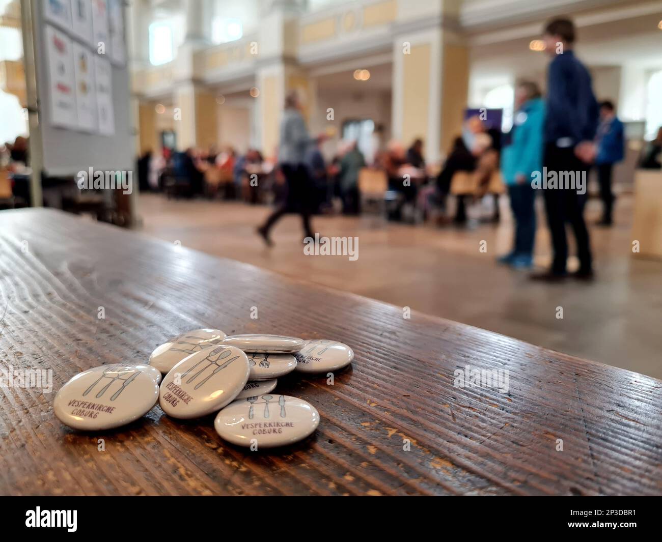 Coburg, Deutschland. 05. März 2023. Die Abzeichen liegen auf einem Tisch bei der Eröffnung einer Vesperkirche im Kirchenhaus von St. Moriz. Die Vesperkirche bietet Mittagessen, kulturelle Veranstaltungen und andere Aktivitäten für zwei Wochen. Kredit: Pia Bayer/dpa/Alamy Live News Stockfoto