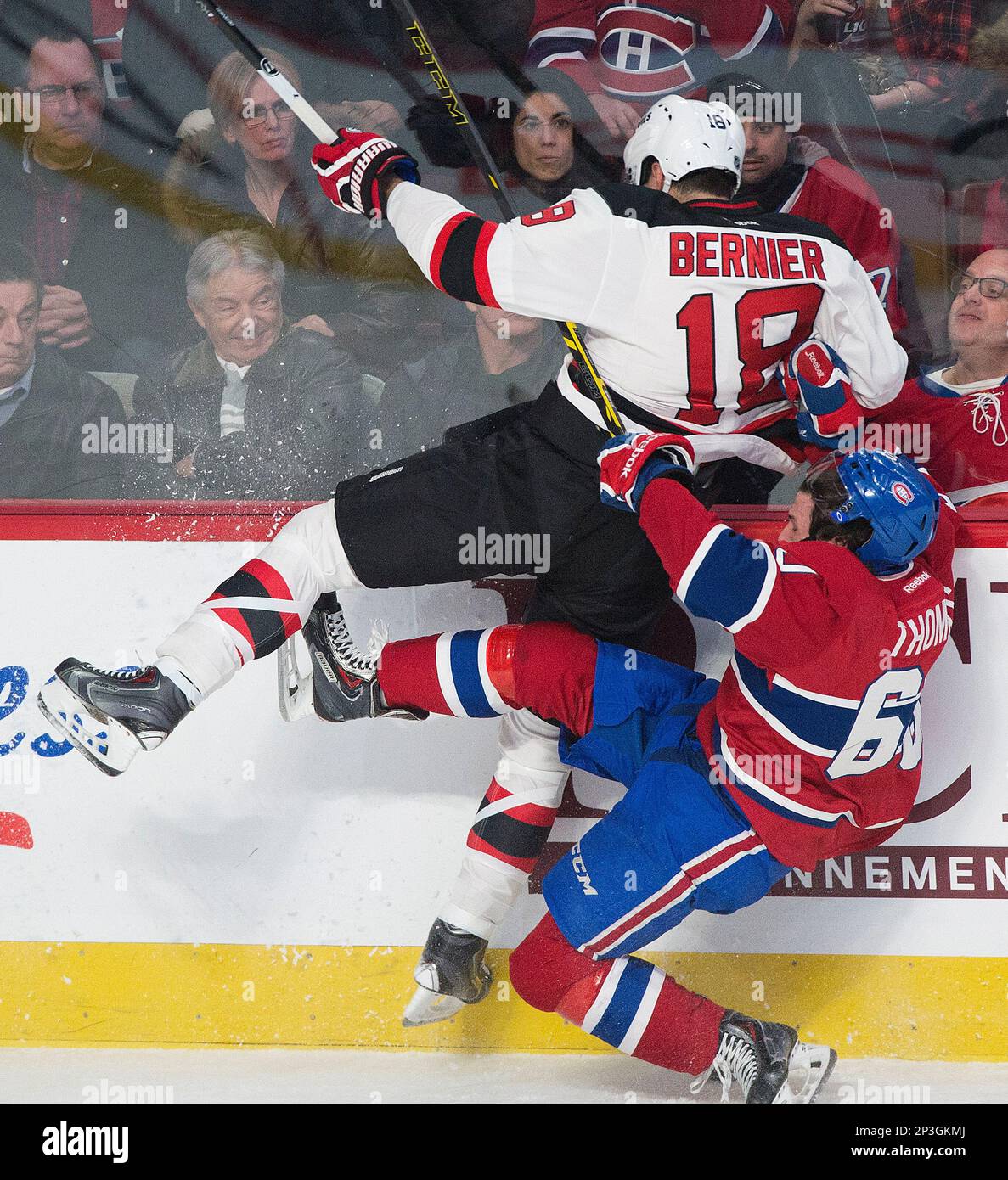 Montreal Canadiens' Christian Thomas, right, collides with New Jersey Devils' Steve Bernier during first-period NHL hockey game action in Montreal, Saturday, Feb. 7, 2015. (AP Photo/The Canadian Press, Graham Hughes) Stockfoto
