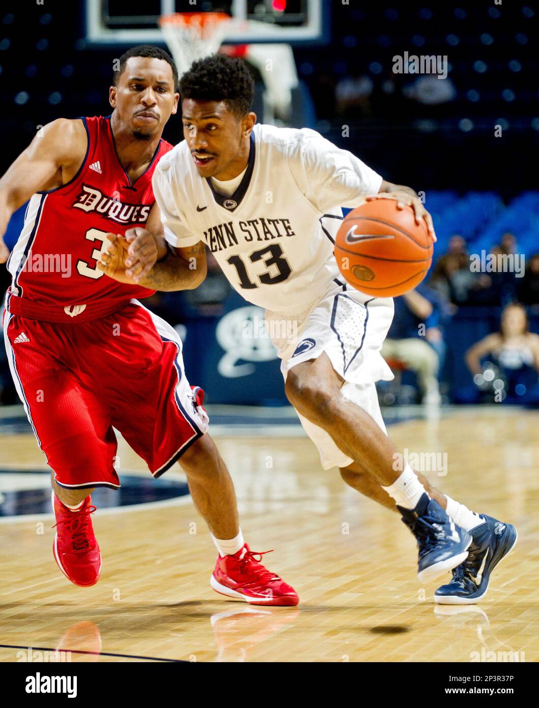 Penn State's Geno Thorpe, right, dribbles around Duquesne's Jordan Stevens during an NCAA college basketball game Wednesday, Dec. 10, 2014, in State College, Pa. (AP Photo/Centre Daily Times, Abby Drey) Stockfoto