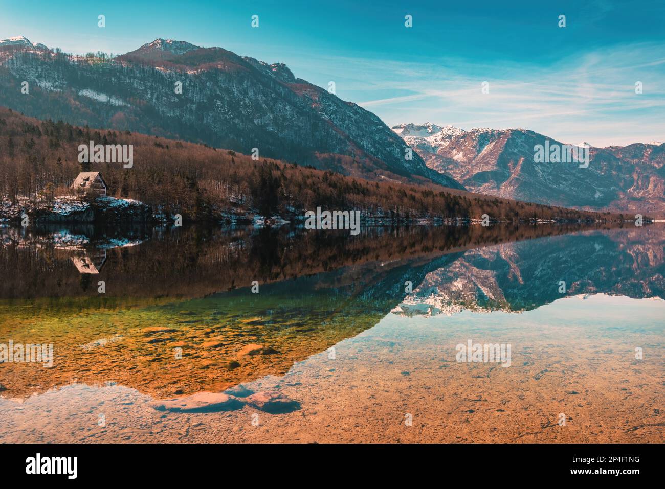 Malerischer Blick auf den Bohinj-See, ein großes Gewässer des Gletschers im slowenischen Nationalpark Triglav am kalten februar-Morgen mit reflektierenden Bergen Stockfoto