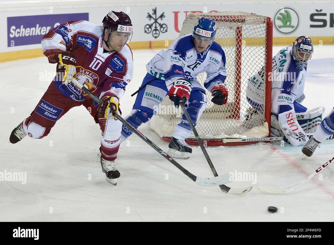 Geneva's Matthew Lombardi, left, challenges for the puck with Rochester's Johan Larsson, second