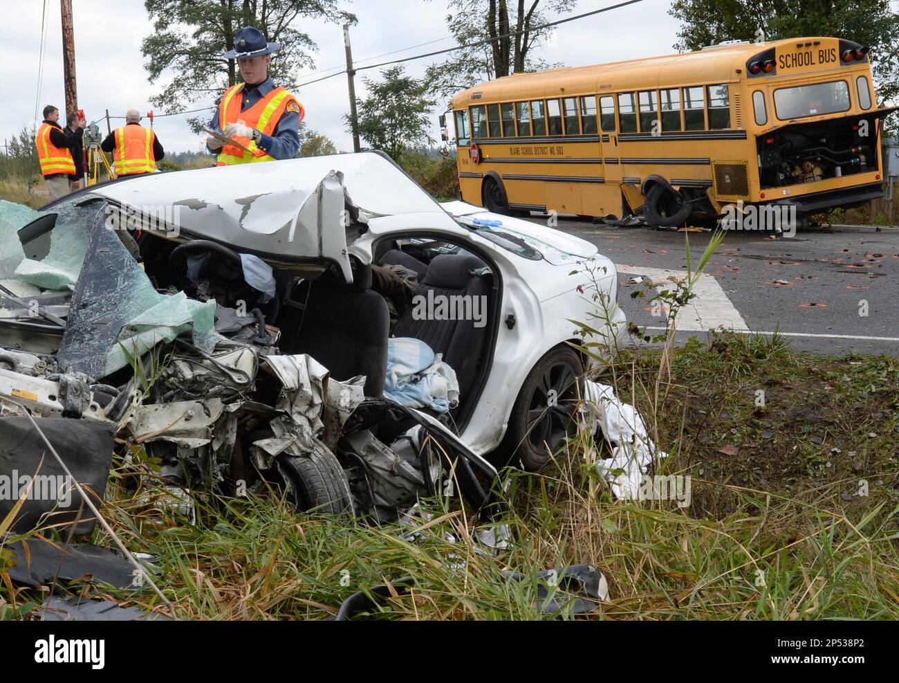 Washington State Patrol officer Brad Beattie, inspects the site of a crash of a Blaine school