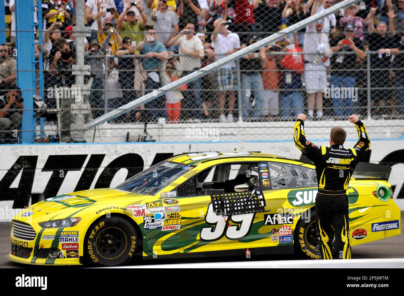 Carl Edwards (99) celebrates his win with a backflip during for the NASCAR Sprint Cup Series SUBWAY FRESH FIT 500 race at Phoenix International Speedway, Sunday, March. 3, 2013, in Phoenix, Az. (AP Photo/Autostock, Nigel Kinrade) MANDATORY CREDIT Stockfoto