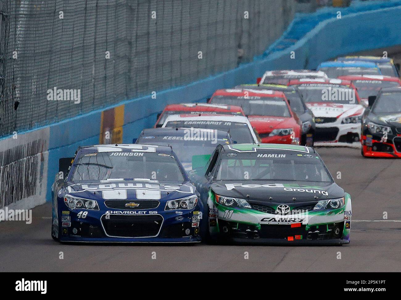 Jimmie Johnson (48) and Denny Hamlin (11) fight for 2nd position as they cross the finish line during the NASCAR Sprint Cup Series Subway Fresh Fit 500 race at Phoenix International Raceway, Sunday, March 3, 2013, in Avondale, Az. (AP Photo/LAT USA, Michael L. Levitt) MANDATORY CREDIT Stockfoto
