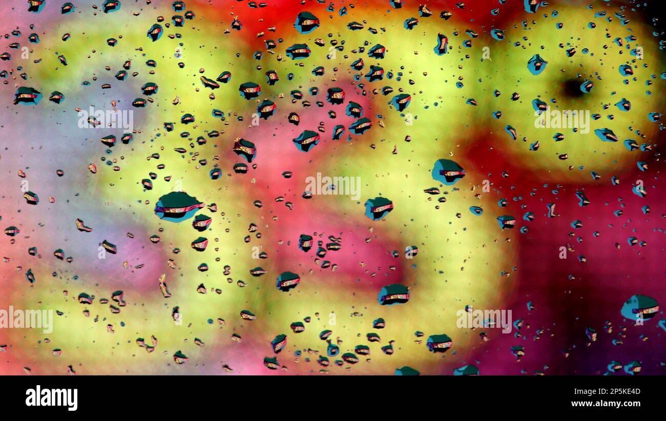 Water droplets on a vehicle window refract the temperature from a sign