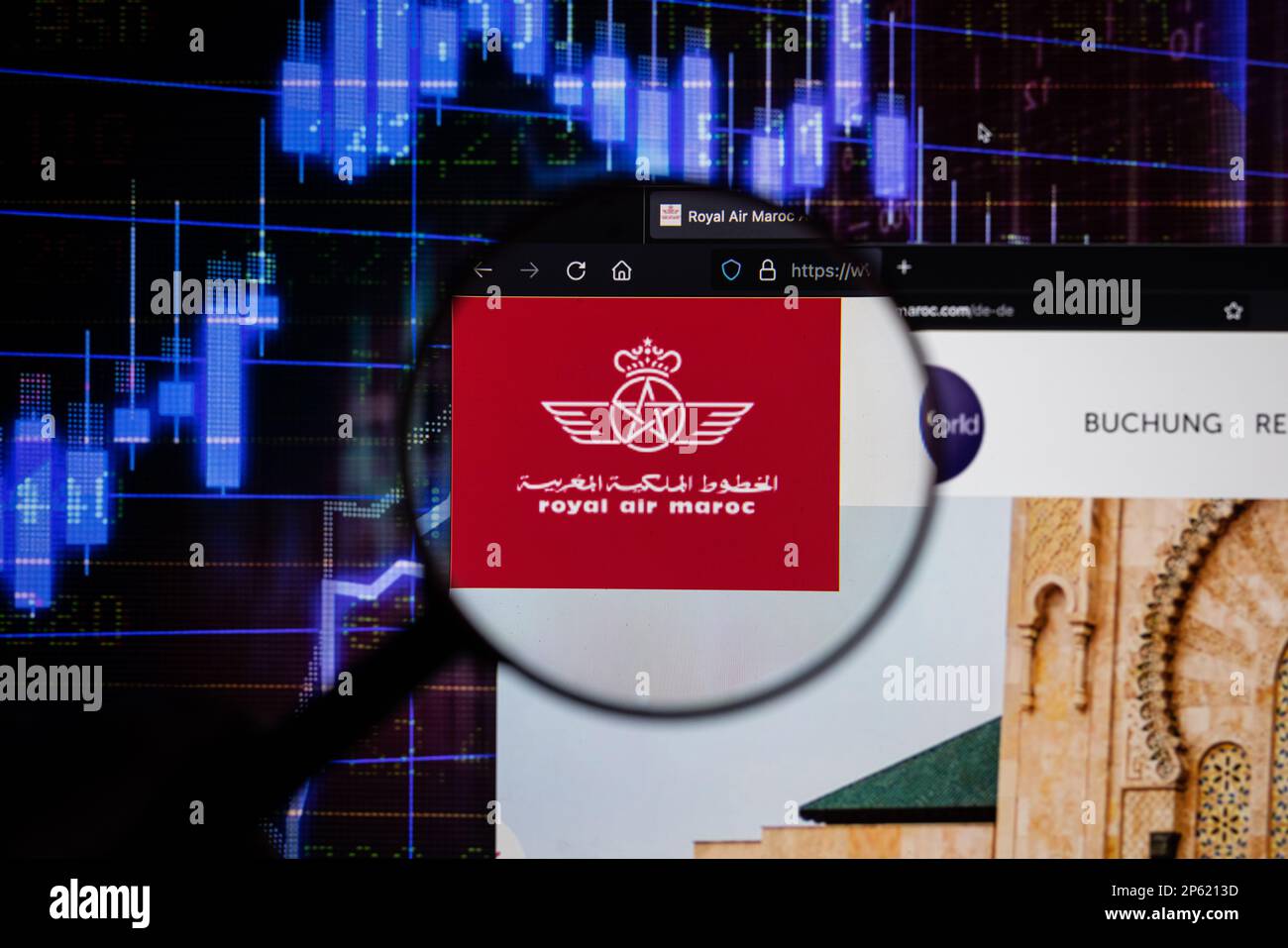 Logo der Fluggesellschaft Royal Air Maroc auf einer Website mit verschwommenen Aktienmarktentwicklungen im Hintergrund, auf einem Bildschirm durch eine Lupe zu sehen Stockfoto