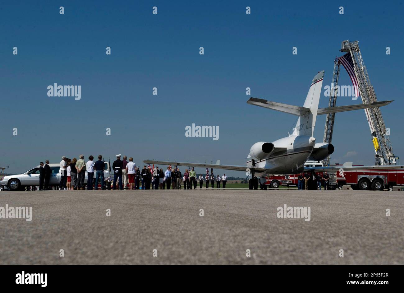 Friends, family and fellow Marines line the tarmac of the Huntingburg