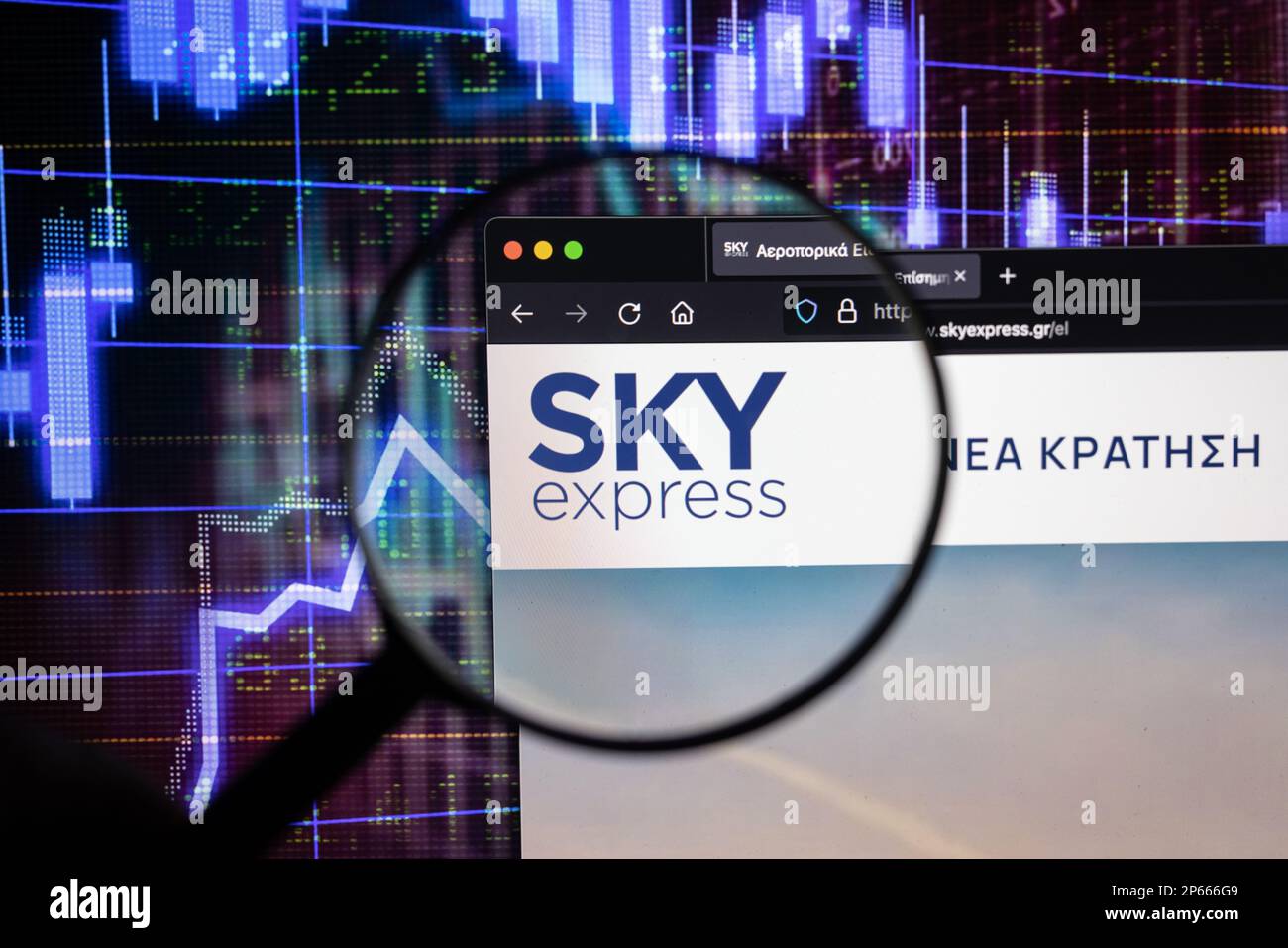 Sky Express Firmenlogo auf einer Website mit verschwommenen Aktienmarktentwicklungen im Hintergrund, auf einem Computerbildschirm durch eine Lupe zu sehen Stockfoto