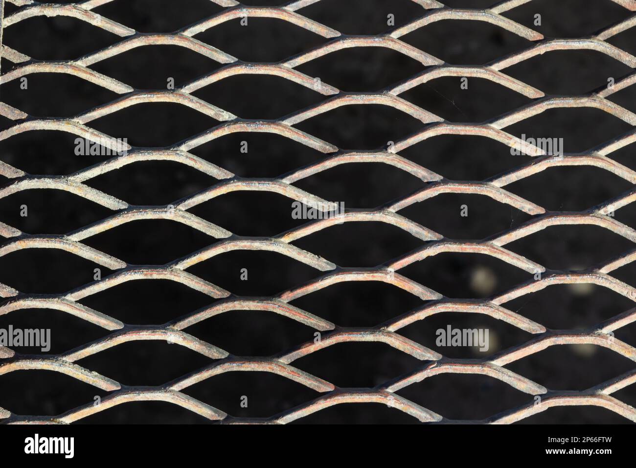 Hintergrund aus einem brillanten Metallgitter auf schwarzem Hintergrund. Stockfoto