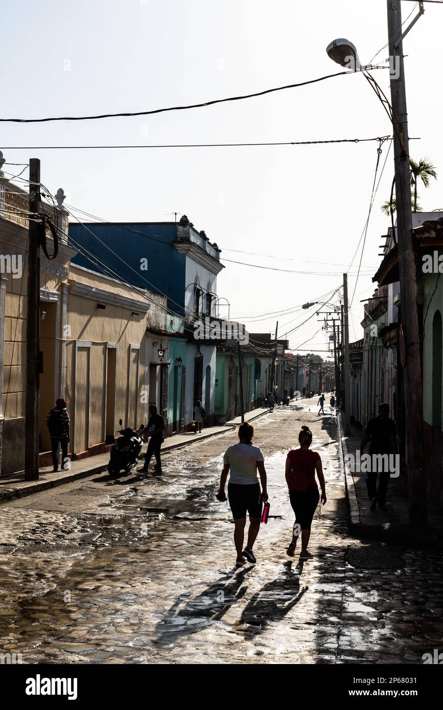 Typische Seitenstraße mit Silhouetten junger Frauen, die hinuntergehen, Trinidad, Kuba, Westindischen Inseln, Karibik, Mittelamerika Stockfoto