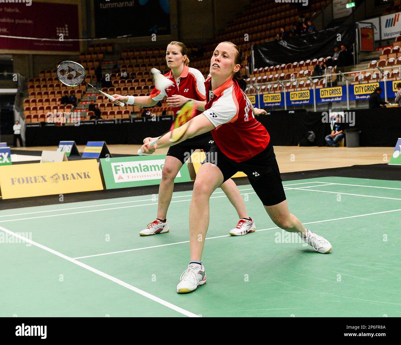 Denmark's Kamilla Rytter Juhl returns the shuttlecock as her partner Christinna Pedersen looks on during the women's doubles final against Denmark's Line Damkjaer Kruse and Marie Roepke at the European Badminton Championships on April 21, 2012, in Karlskrona, Sweden. (AP Photo/Patric Soderstrom/Scanpix Sweden) Stockfoto