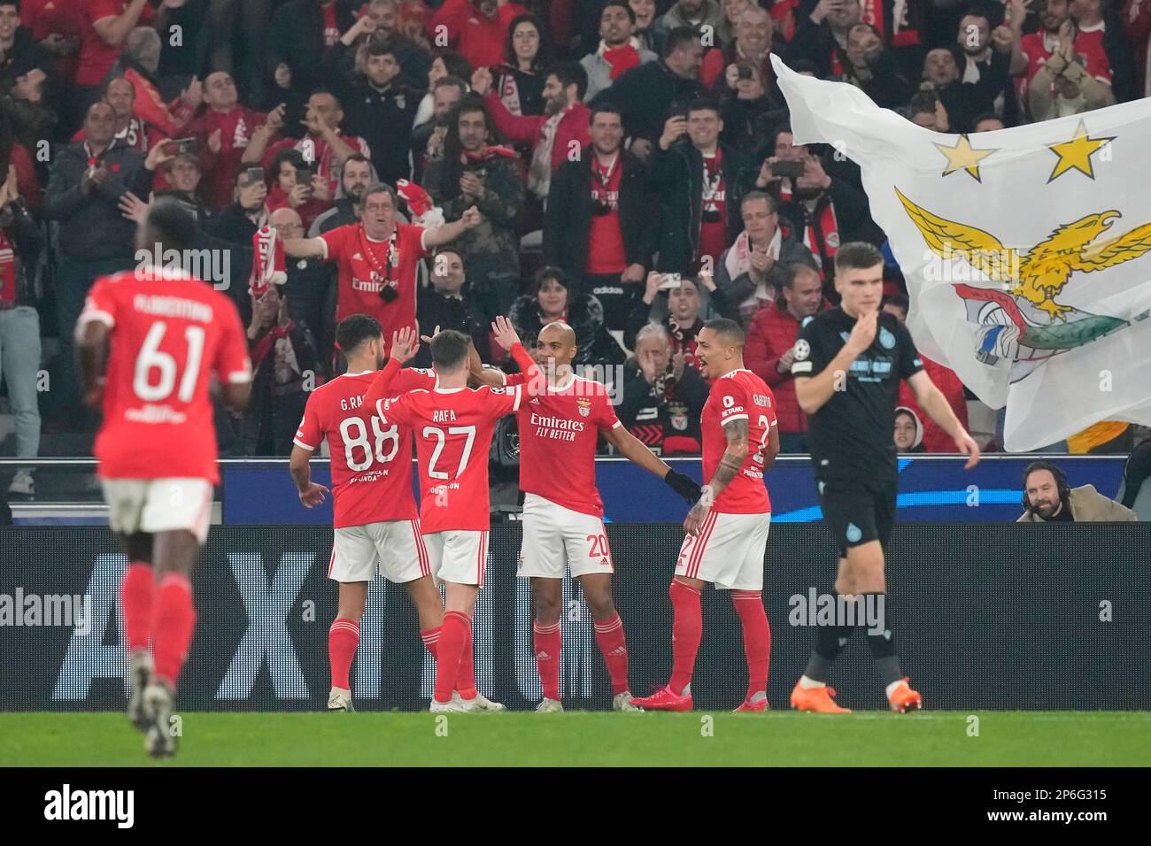 Benfica's Joao Mario, second right, celebrates after scoring his side's fourth goal from the penalty spot during the Champions League, round of 16, second leg soccer match between Benfica and Club Brugge at the Luz stadium in Lisbon, Portugal, Tuesday, March 7, 2023. (AP Photo/Armando Franca) Stockfoto