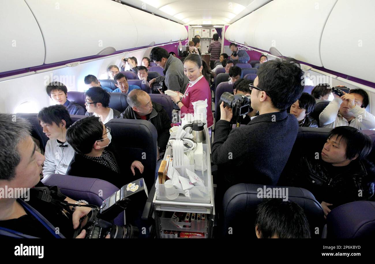 Cabin attendants serve meals in the the first flight of Peach Aviation, Japanese lowcost