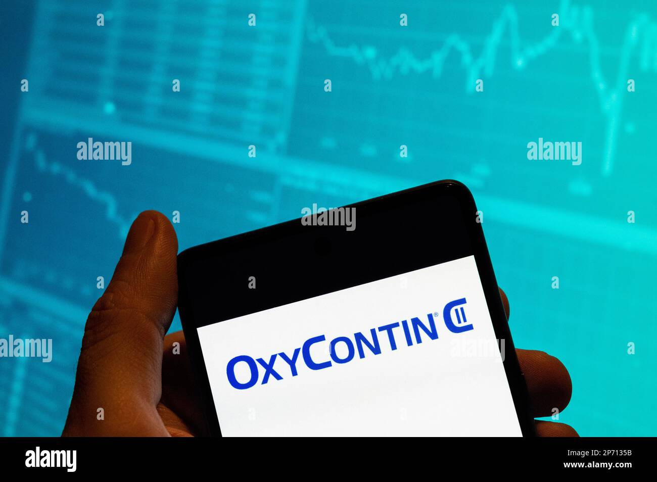 China. 15. Februar 2023. In dieser Fotoabbildung wird das OxyContin-Schmerzmittel, das von dem Pharmaunternehmen produziert wird, das sich im Besitz der Familie Sackler befindet und für die Opioidkrise der USA verantwortlich ist, Purdue Pharma, Logo auf einem Smartphone mit einer Grafik des Börsenindex im Hintergrund angezeigt. Kredit: SOPA Images Limited/Alamy Live News Stockfoto