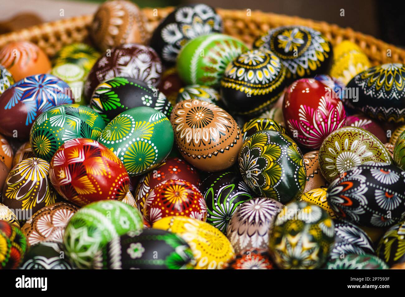 Traditionelle litauische farbenfrohe Ostereier aus Holz in einem Korb aus Korb aus Korb, ein Symbol der Fruchtbarkeit und des Lebens mit den Symbolen der Natur Stockfoto