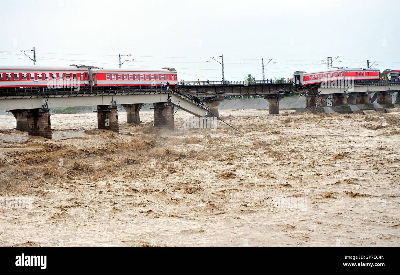 A train is seen derailed on a collapsed bridge at the Shiting River in