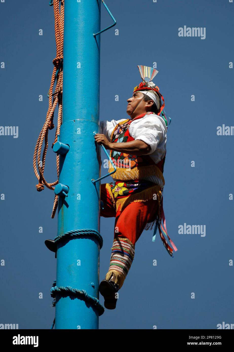 Voladores Ritual Performance A Volador de Papantla or Flying Men of Papantla climbs a pole during a ...
