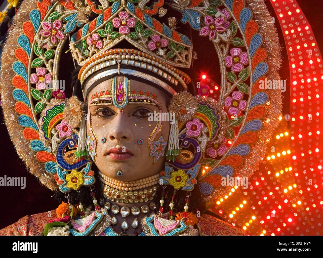 An Indian artist dressed as Hindu god Rama looks on from a tableau ...