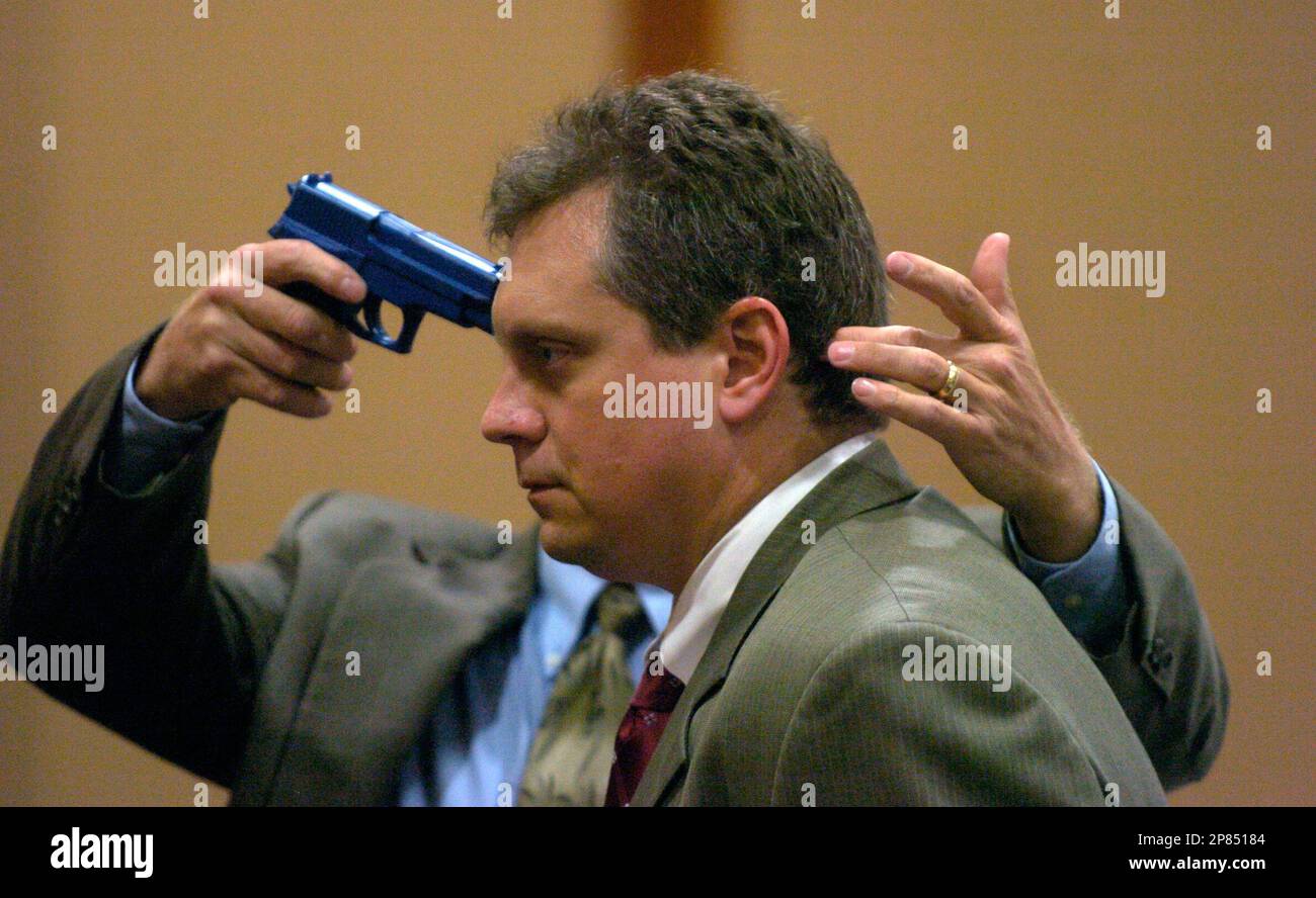 Assistant State Attorney Lon Arend models for Dr. Dan Schultz, a forensic pathologist who