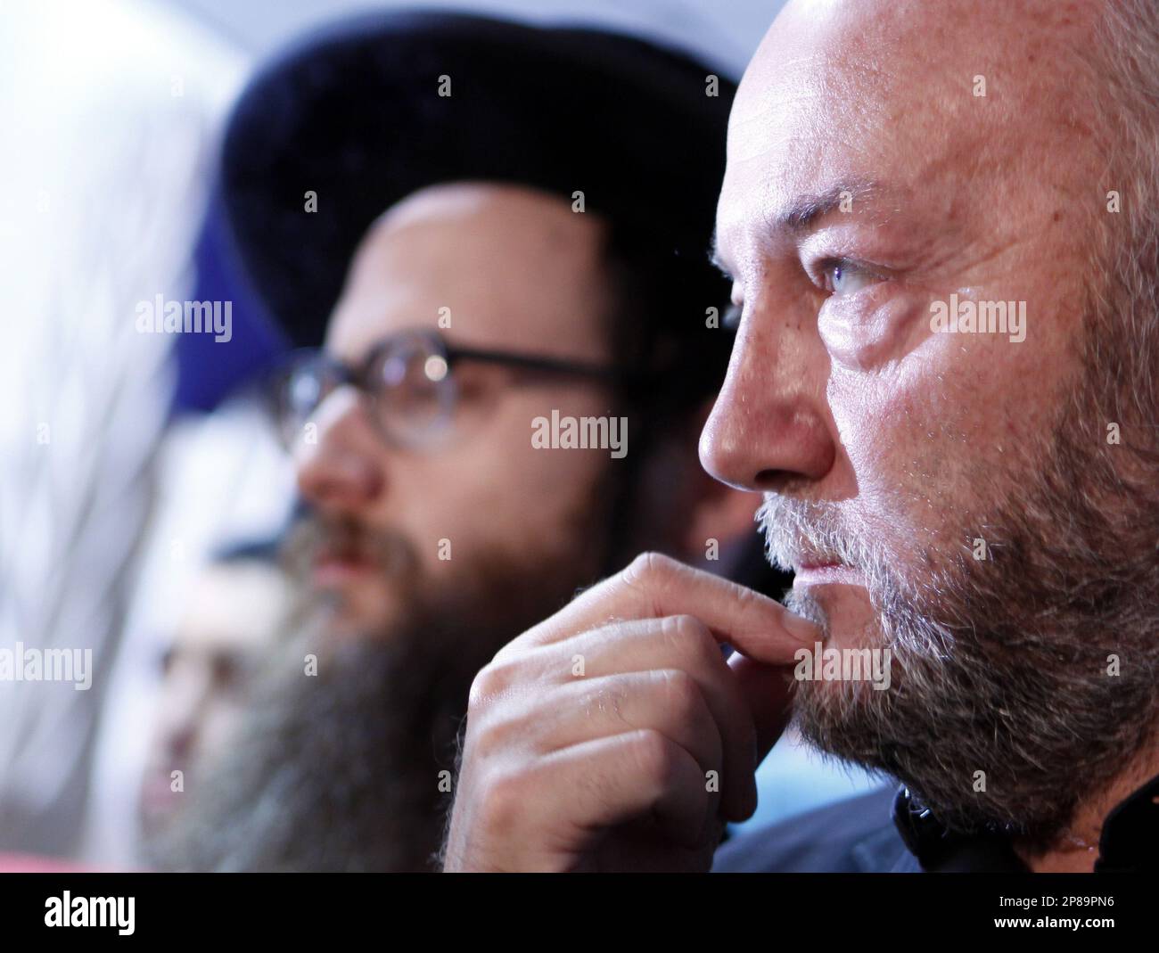 British lawmaker George Galloway, right, looks on as he delivers a speech at the syndicate of Journalists in Cairo, Egypt, Wednesday, July 8, 2009. About 100 U.S. activists arrived in Egypt on their way to Gaza, hoping to deliver medical aid, trucks and support for lifting a 2-year old Israeli-Egyptian blockade of the territory. An anti-Zionist Orthodox Jew at background. (AP Photo/Amr Nabil) Stockfoto