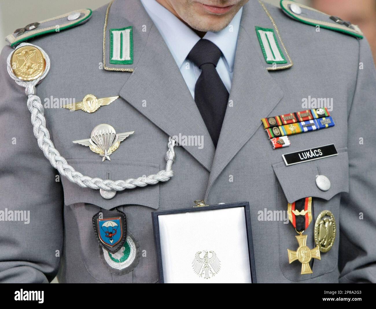Bundeswehr Master Sgt. Henry Lukacs is presented with the Cross of