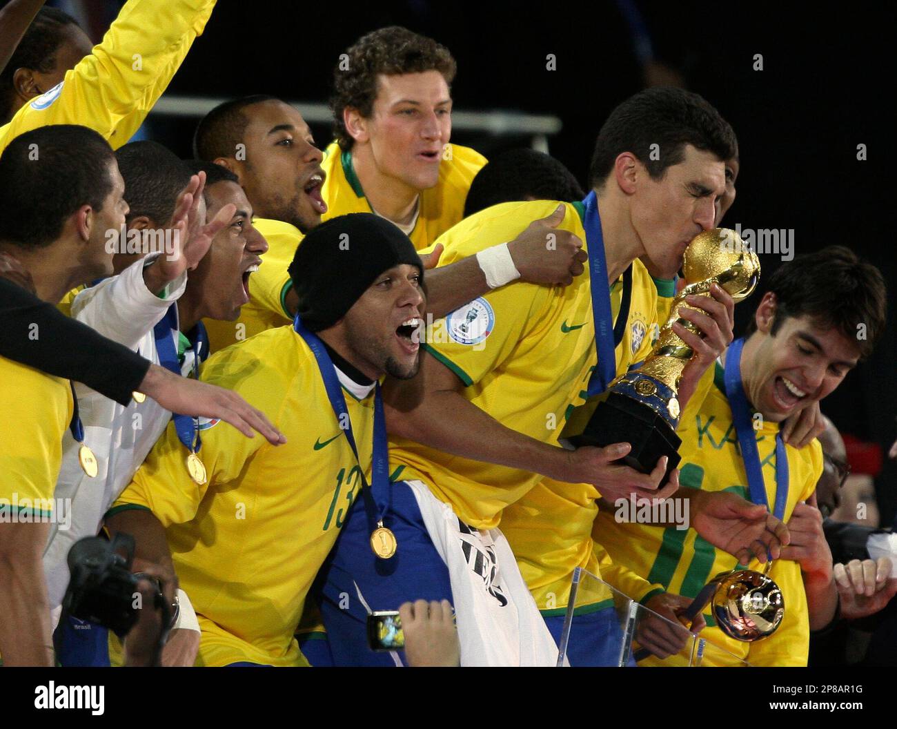 Brazil's Lucio, second from right, kisses the Confederations Cup trophy, as he and fellow team members celebrate after their Confederations Cup final soccer match against the US, at Ellis Park Stadium in Johannesburg, South Africa, Sunday, June 28, 2009. Brazil won 3-2. (AP Photo/Andre Penner) Stockfoto