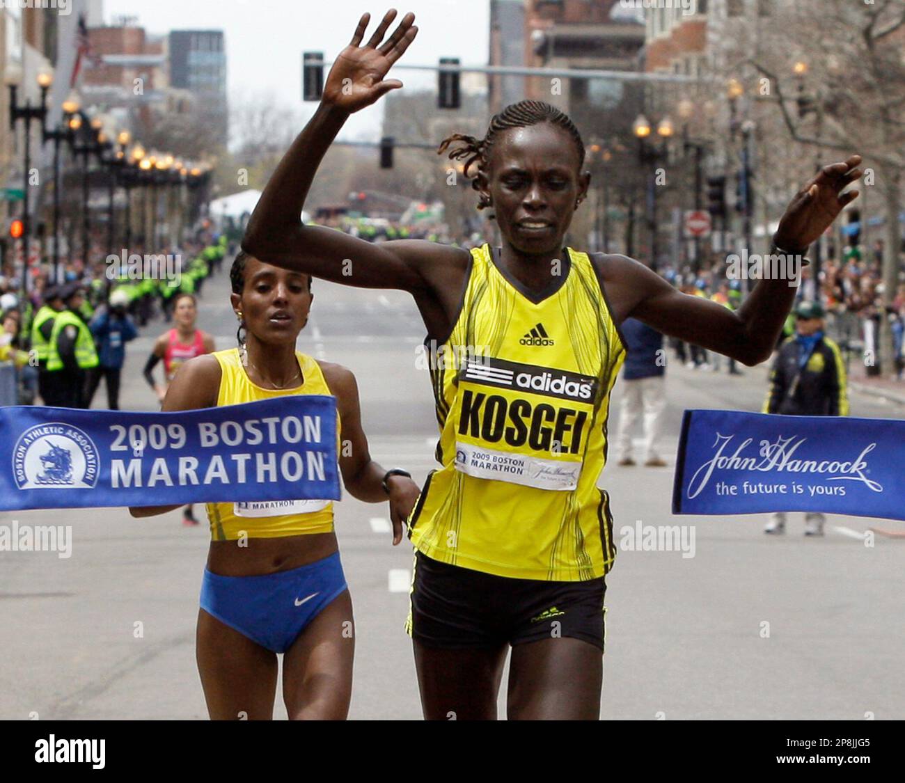 Womens winner Salina Kosgei of Kenya breaks the tape ahead of Dire Tune