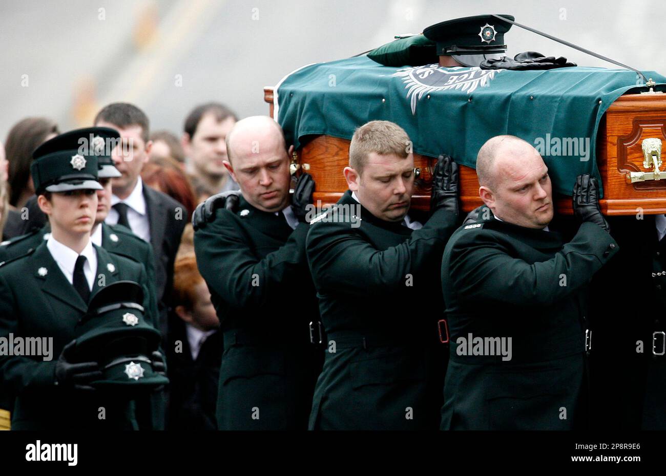 Police Service of Northern Ireland Officers carry the coffin of their