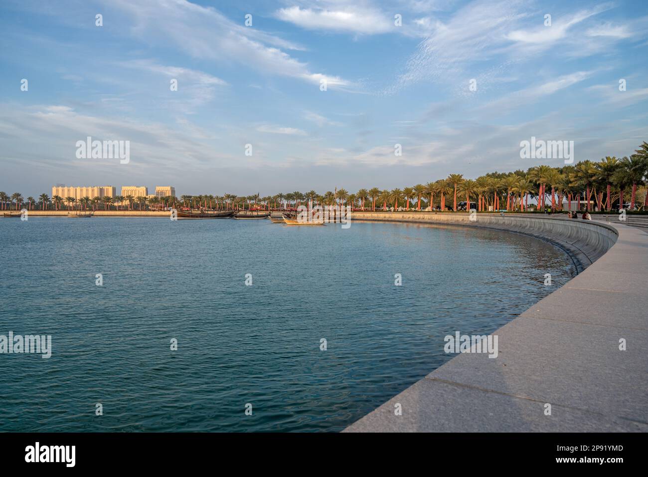 Die Skyline von Doha kann vom MIA Park aus gesehen werden und drei Dhow-Boote im Vordergrund. Stockfoto