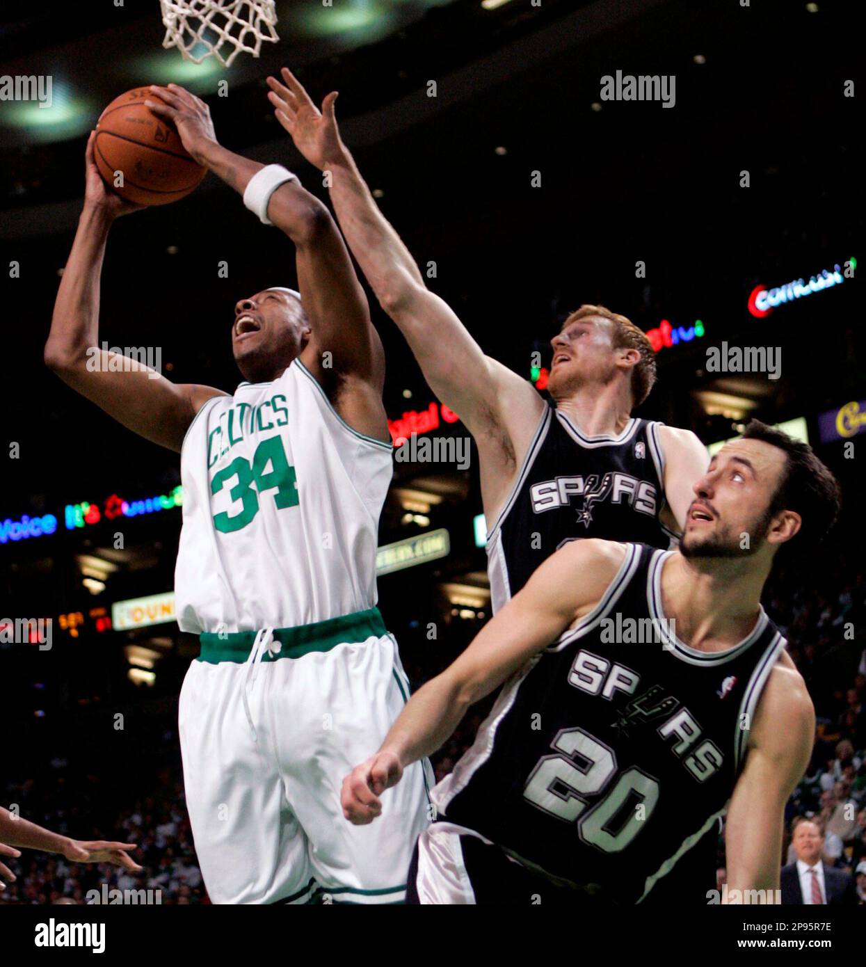 Boston Celtics' Paul Pierce (34) tries to get a shot off against San Antonio Spurs' Matt Bonner, top right, and Manu Ginobili (20), of Argentina, during the fourth quarter of an NBA basketball game Sunday, Feb. 8, 2009, in Boston. The Spurs won 105-99. (AP Photo/Michael Dwyer) Stockfoto