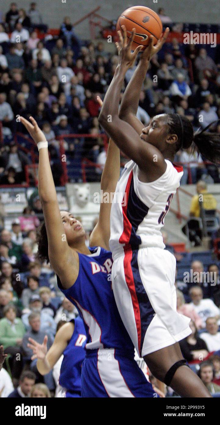 Connecticut's Tina Charles goes up past DePaul's Felicia Chester for a shot in the second half of an NCAA college basketball game at Storrs, Conn., Tuesday, Jan. 13, 2009. Connecticut defeated DePaul 77-62. (AP Photo/Bob Child) Stockfoto