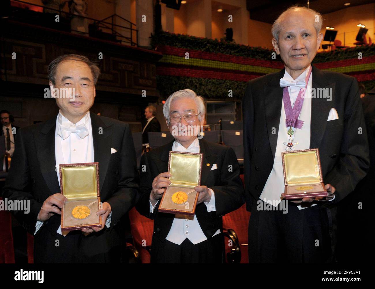Japan's Makoto Kobayashi, left, and Toshihide Maskawa, center, co