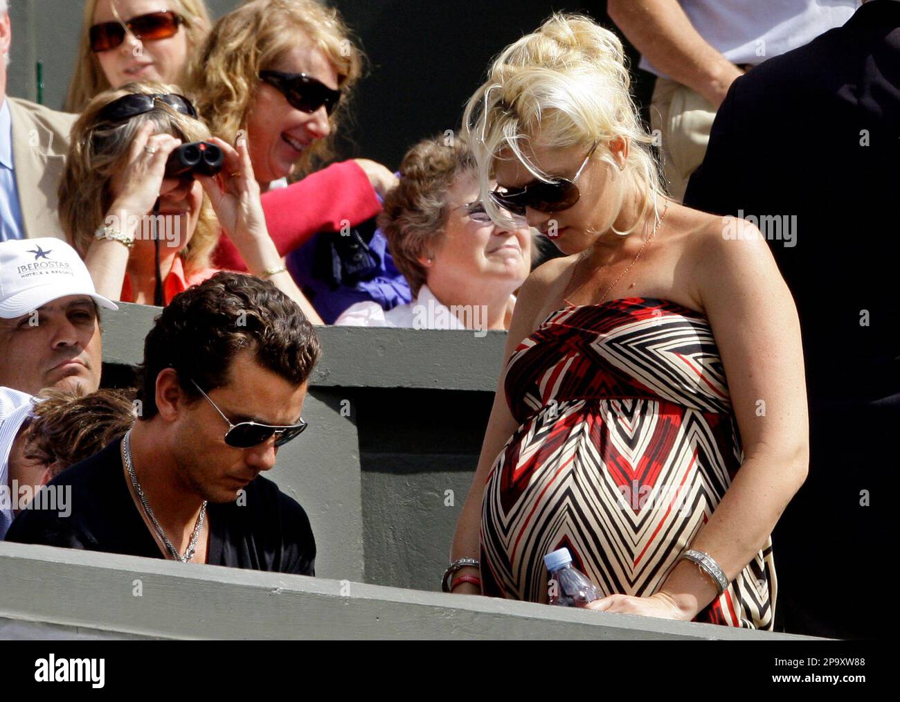 US singer Gwen Stefani right, pictured with her husband Gavin Rossdale in  the players box as they watch Switzerland's Roger Federer in action against  Spain's Rafael Nadal during the men's final on