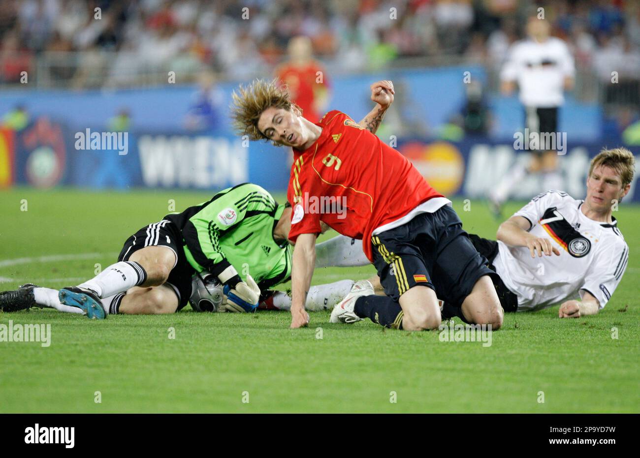 Spain's Fernando Torres, center, challenges for the ball with Germany's Jens Lehmann, left, and Per Mertesacker during the Euro 2008 final between Germany and Spain in the Ernst-Happel stadium in Vienna, Austria, Sunday, July 29, 2008, the last day of the European Soccer Championships in Austria and Switzerland. (AP Photo/Ivan Sekretarev) Stockfoto