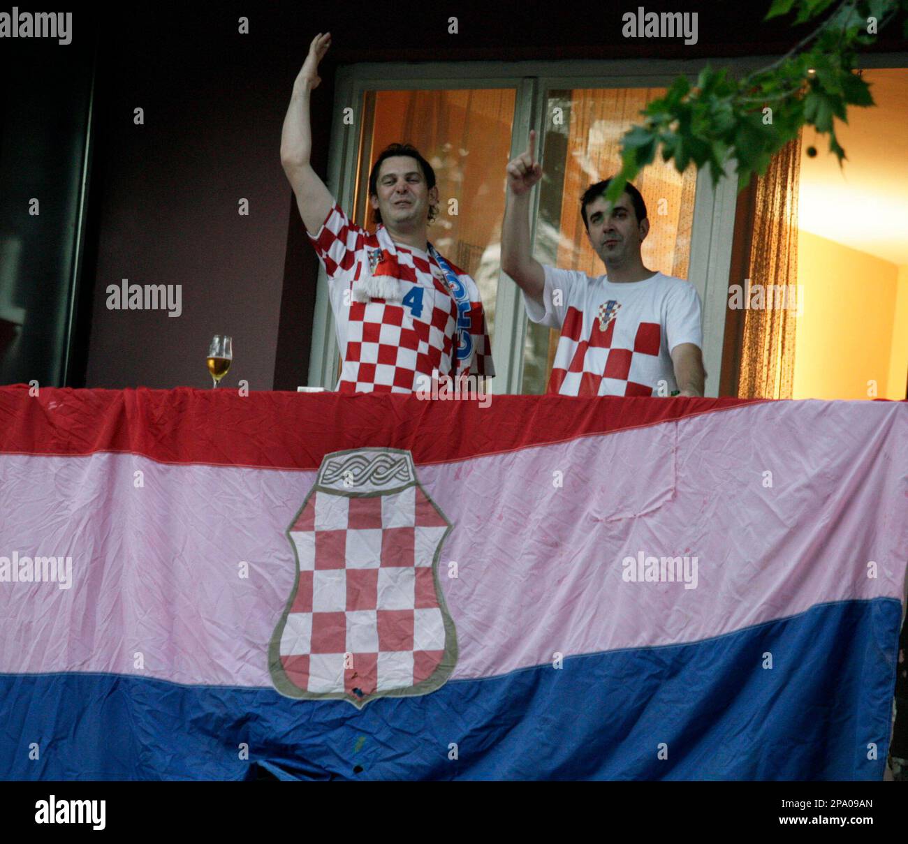 Bosnian Croats, supporters of Croatian national team at EURO 2008, cheer from their balcony in Mostar, Bosnia Herzegovina Friday, June 20 , 2008, before Croatia's game against Turkey. Turkey won the match which caused general euforia in Eastern, mostly Muslim, part of Mostar. Antagonism lead to inter ethnic tension in divided city but situation was successfully contained by local police. (AP Photo/Hidajet Delic) Stockfoto