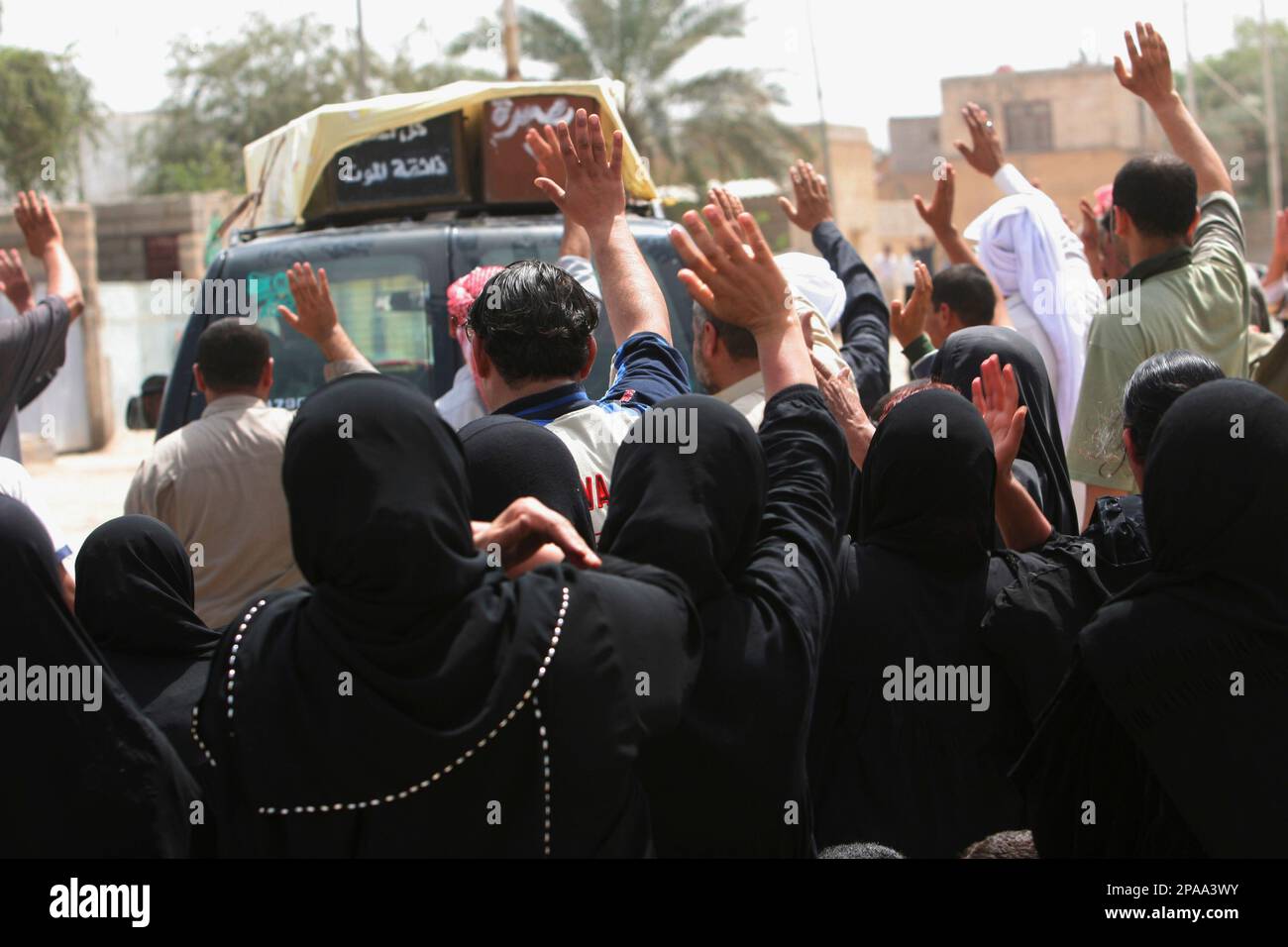 Relatives wave goodbye as cars take away the coffins of Mohammed Rijab ...