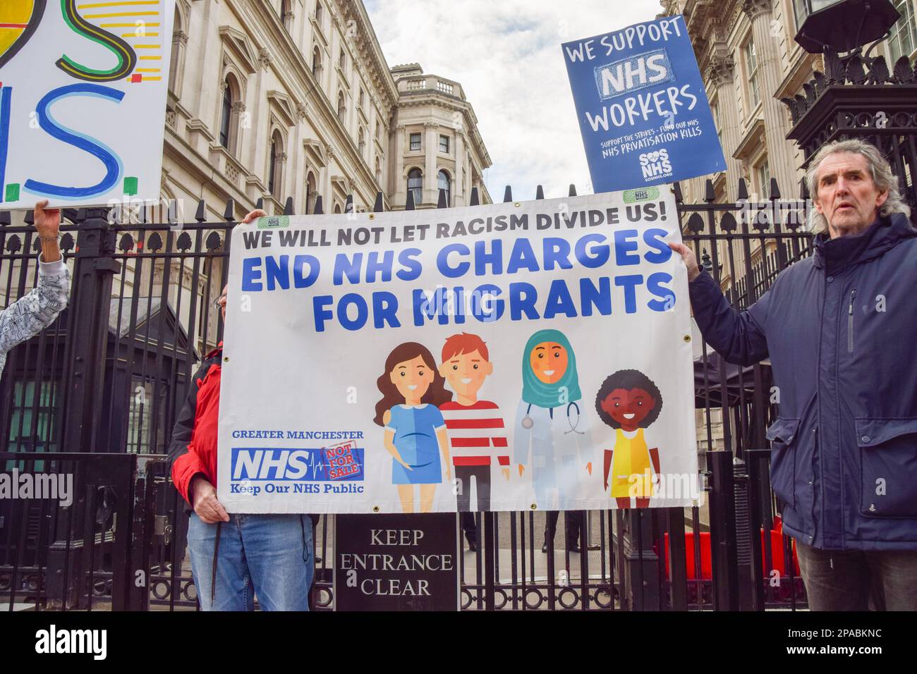 London, Großbritannien. 11. März 2023. Während der Demonstration außerhalb der Downing Street halten Demonstranten ein Banner in der Hand, in dem sie die Einstellung der Anklage des NHS gegen Migranten fordern. Tausende von Menschen marschierten durch das Zentrum von London, um den NHS (National Health Service) und NHS-Arbeiter zu unterstützen und gegen die Privatisierung des NHS zu protestieren. (Foto: Vuk Valcic/SOPA Images/Sipa USA) Guthaben: SIPA USA/Alamy Live News Stockfoto