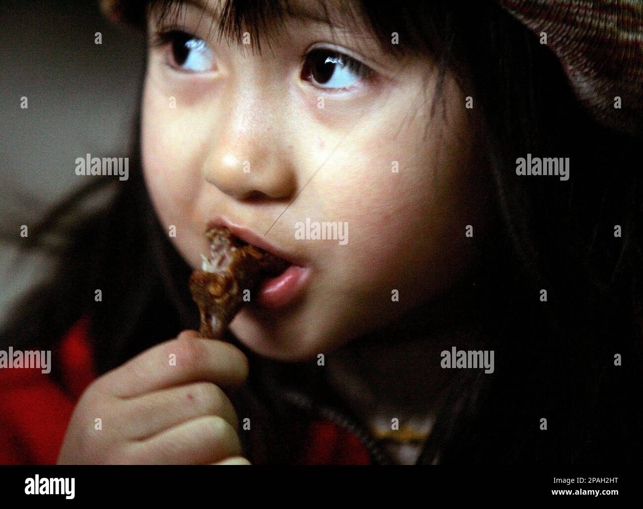 Nguyen Kim Truc, 5, eats a fried rat at her uncle's home in Dinh Bang ...