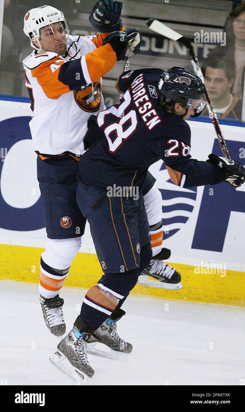 New York Islanders' MarcAndre Bergeron collides with Edmonton Oilers