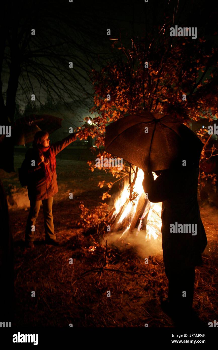 Bosnian Serb people standing near a fire of the dried oak branches the