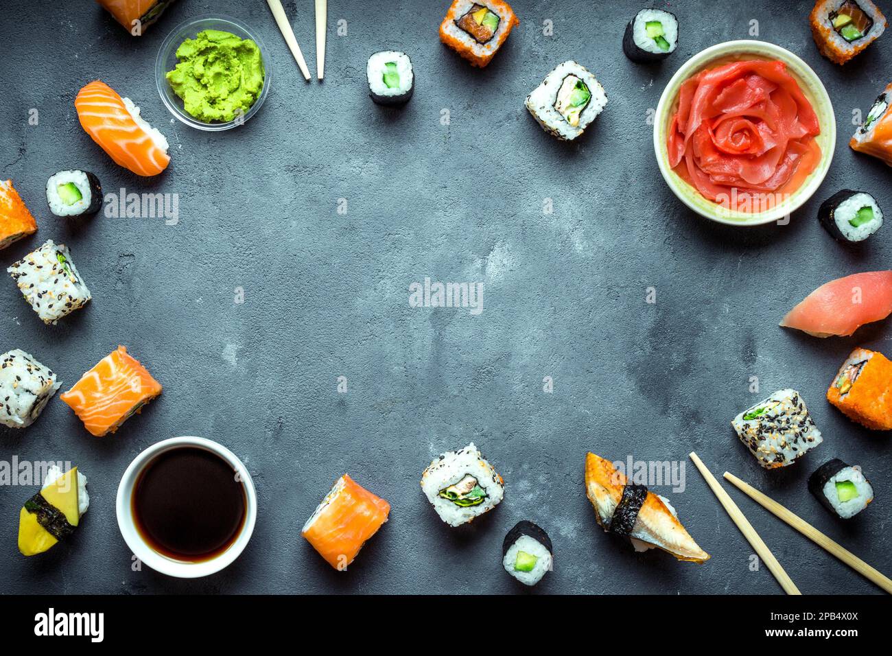 Japanisches Sushi auf dunklem Hintergrund. Sushi-Brötchen, Nigiri, Maki, eingelegter Ingwer, Wasabi, sojasoße. Sushi auf einem Tisch. Platz für Text. Draufsicht. Sus Stockfoto